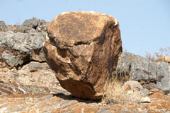 a balanced rock with a scary face